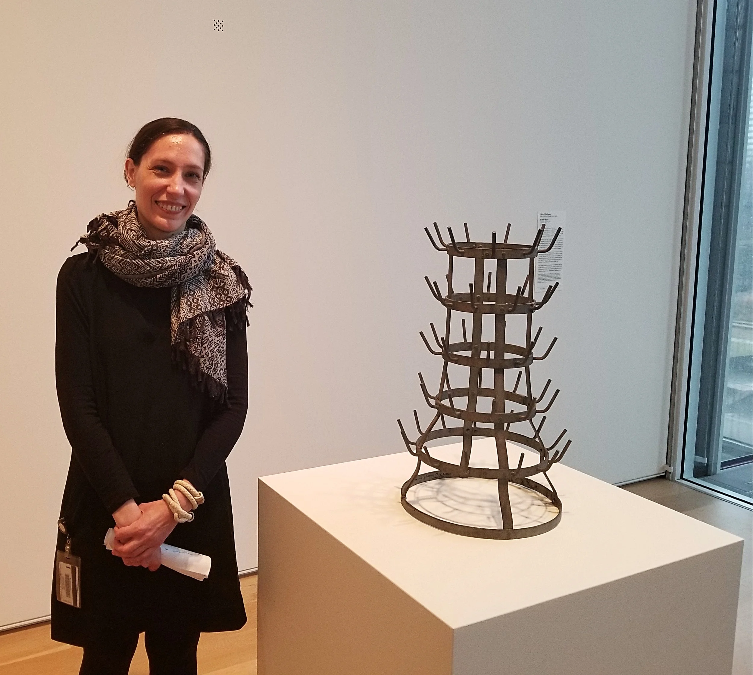Katja Dominique Rivera, research associate in the department of modern and contemporary art at the Art Institute of Chicago, next to Duchamp's "Bottle Rack"