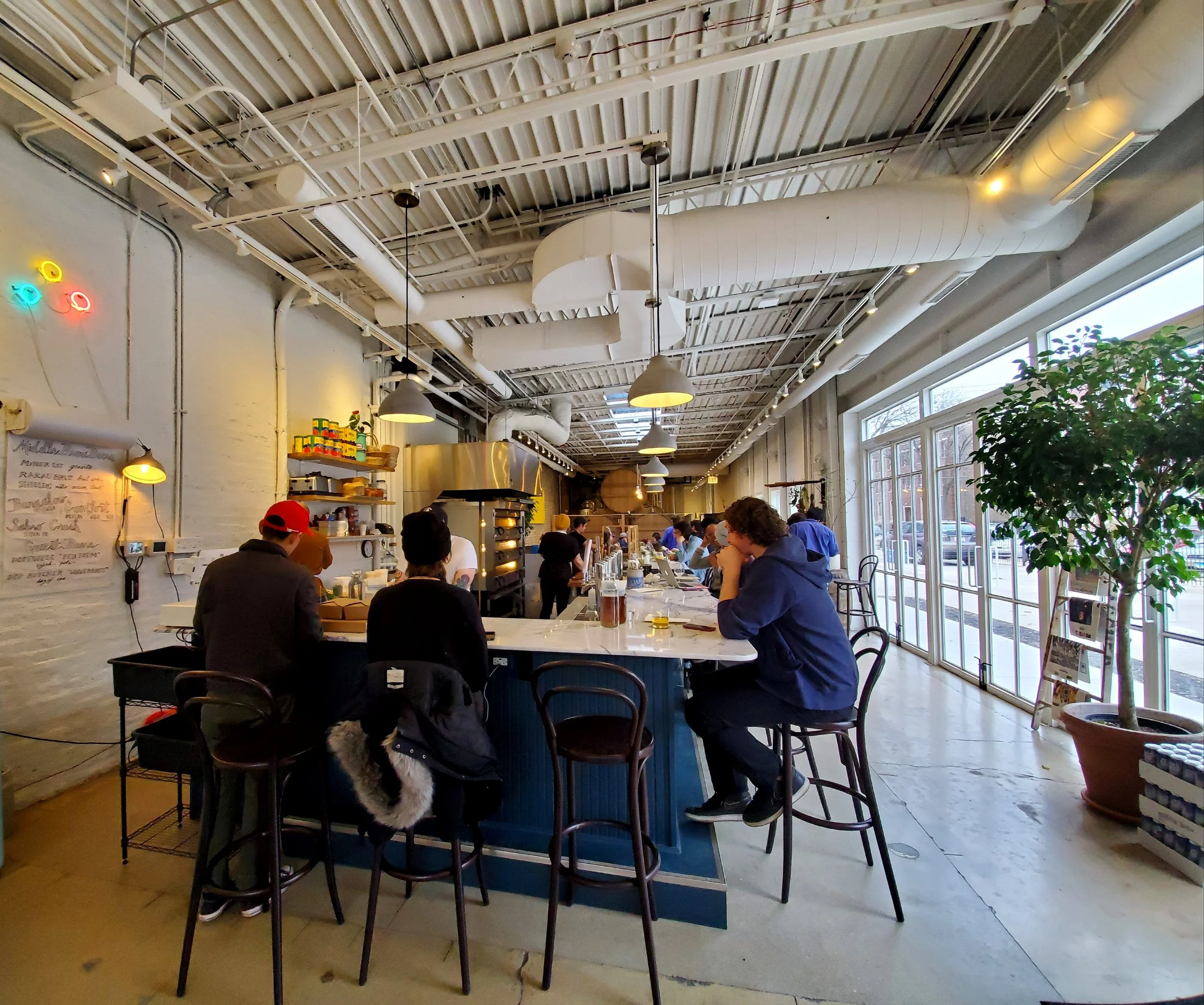 A look inside Bugnalow, where the bar surrounds an open kitchen.