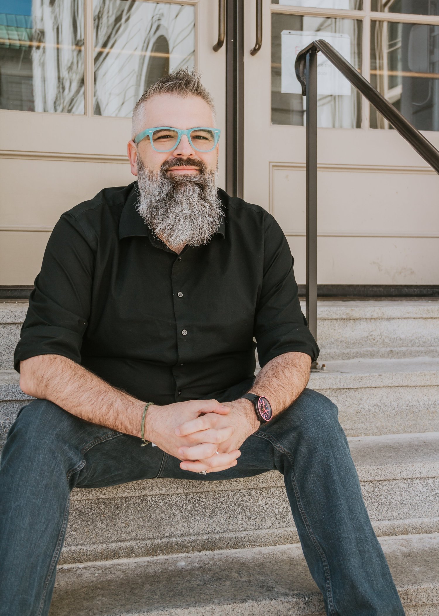Scott Pinyard seated outside, smiling at the camera