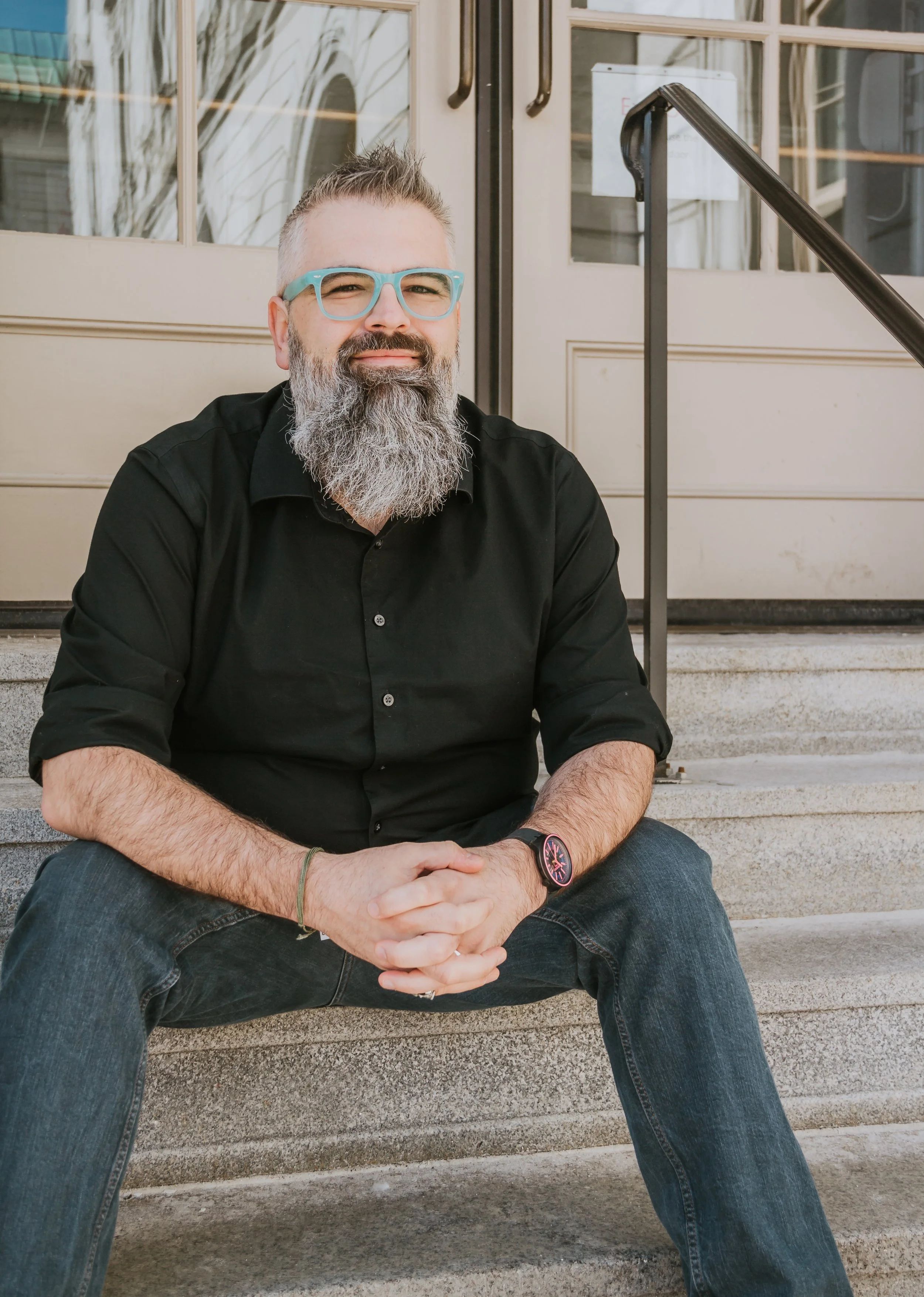 Scott Pinyard seated on outdoor steps