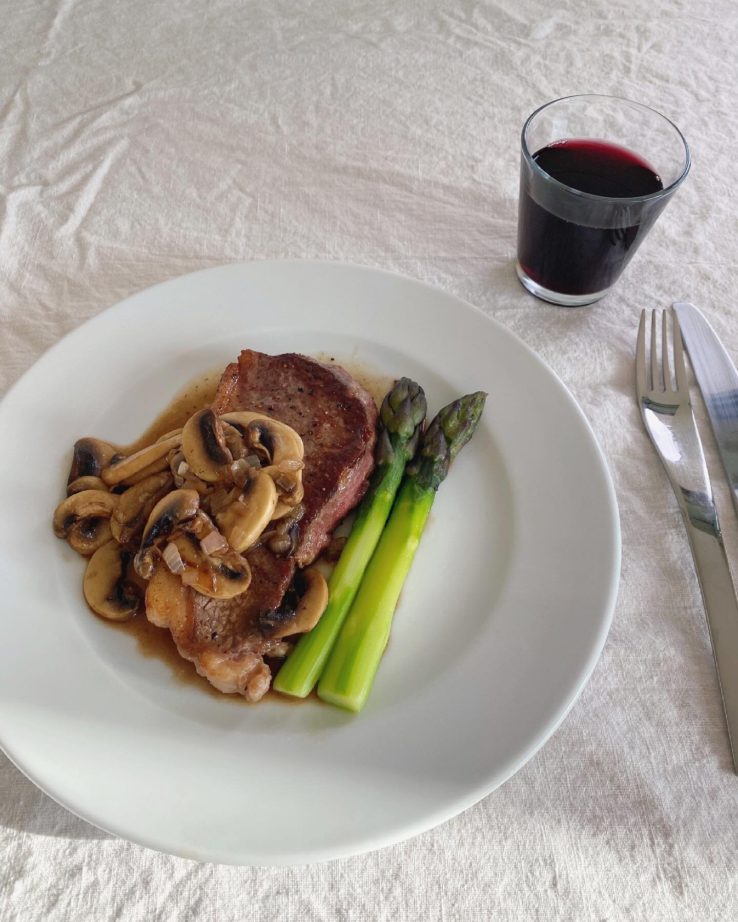 Grass fed NY strip, purple asparagus, brandied mushrooms, a glass of Cabernet Franc natural.