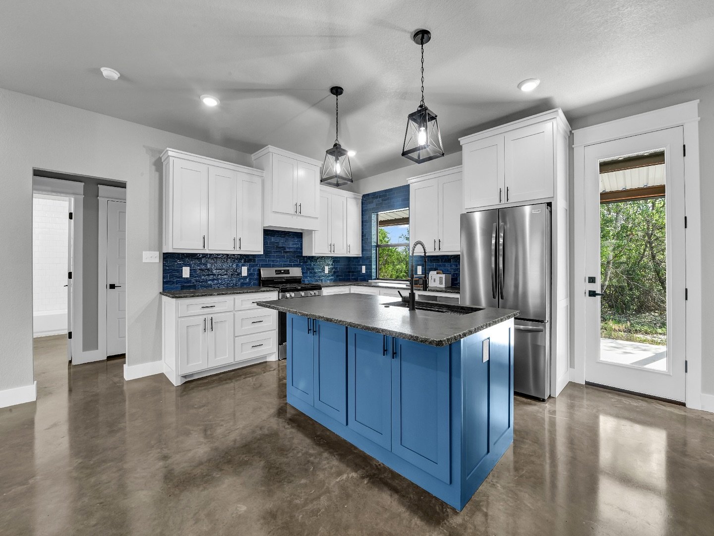 One of our favorite features in this newly finished barndo? The bold blue island and coordinating tile backsplash that bring just the right amount of personality to the kitchen!

Color can completely transform a space, and this rich blue adds energy,