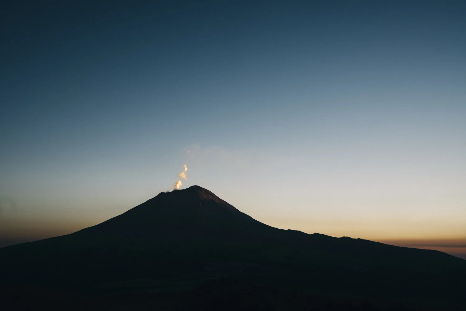 Volcanic gas rises from Mt. Popocatepetl, The Warrior, at sunset.