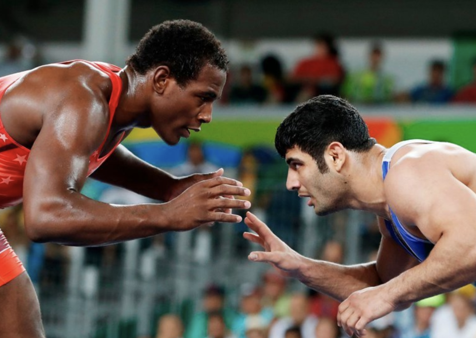 Alireza Karimi, right, loses to American J’Den Cox at the 2016 Olympics in Rio de Janeiro, to avoid wrestling an Israeli in the following round. (Photo: CreditJack Guez/Agence France-Presse — Getty Images)
