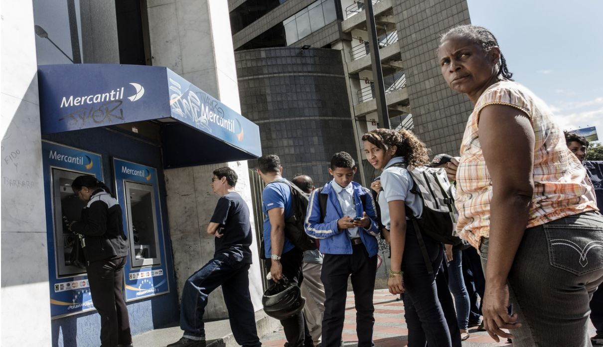 Photo: Venezuelans stand in line to withdraw cash from an ATM at the height of the cash crisis. Source: The Wall Street Journal
