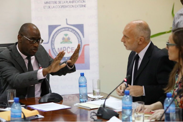 Aviol Fleurant, Haiti’s minister of planning and external cooperation, left, meeting on Thursday with the Oxfam officials Simon Ticehurst and Margalida Massot (New York Times) 