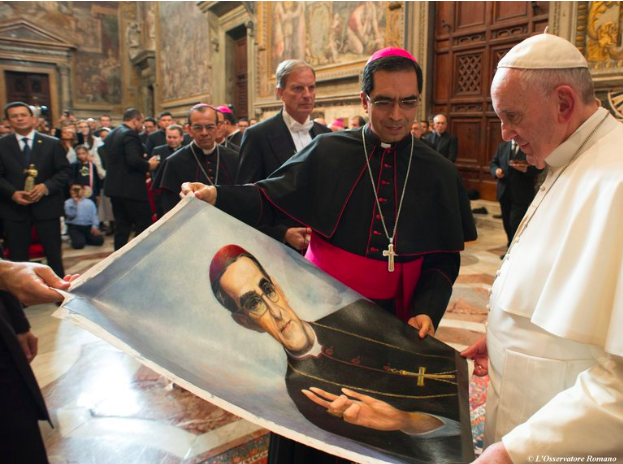 Pope Francis is presented with an image of Archbishop Óscar Romero in 2015 (New York Times)