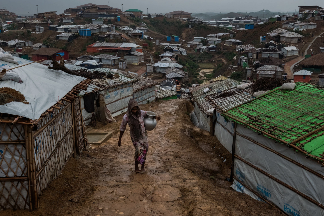 A Rohingya refugee carrying water through a refugee camp in Bangladesh. Photo: Rebecca Conway, The New York Times
