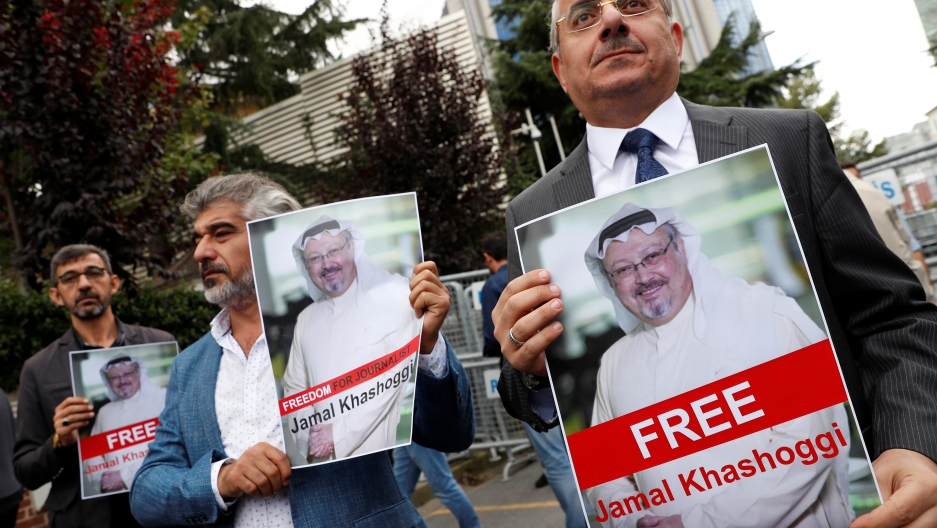 Human rights activists and friends of Saudi journalist Jamal Khashoggi hold his pictures during a protest outside the Saudi Consulate in Istanbul, Turkey. Oct. 8, 2018. Credit: Murad Sezer/Reuters