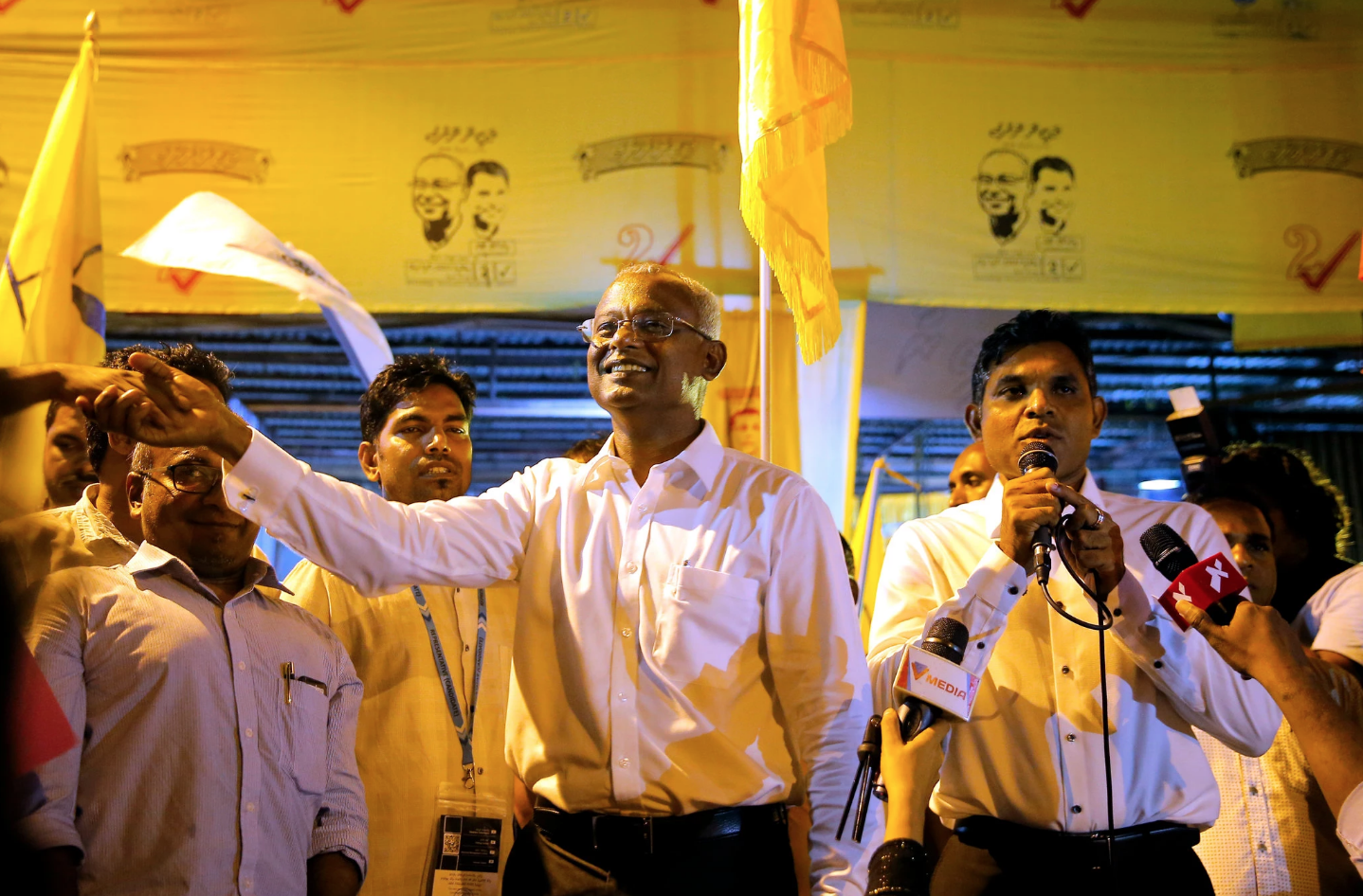 Solih, center, at a campaign with his running mate, Faisal Naseem, on the right, at a rally in Male, Maldives on September 24. Photo: Eranga Jayawardena/Associated Press