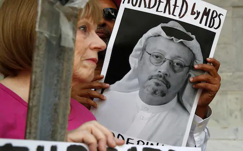 People hold signs during a protest at Washington’s Saudi Arabian Embassy about the disappearance of Saudi journalist Jamal Khashoggi Credit: AP