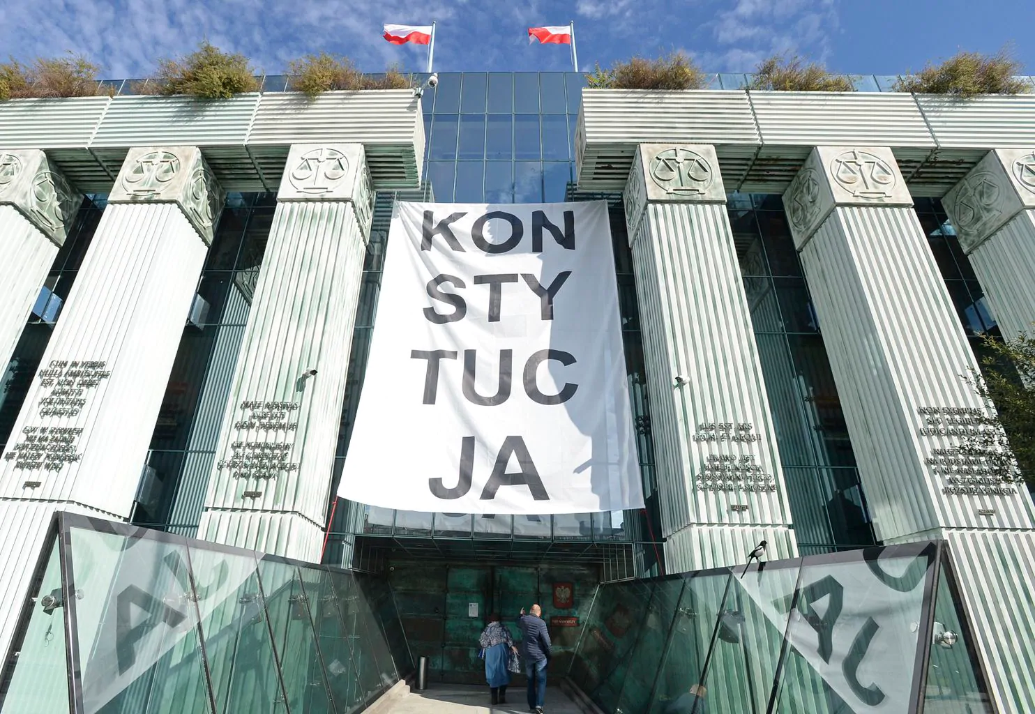 A banner reading “CONSTITUTION” — protesting the judicial reforms undertaken by the governing Law and Justice Party — hangs at the Supreme Court building in Warsaw on Oct. 11, 2018. Photo: Alik Keplicz/AP