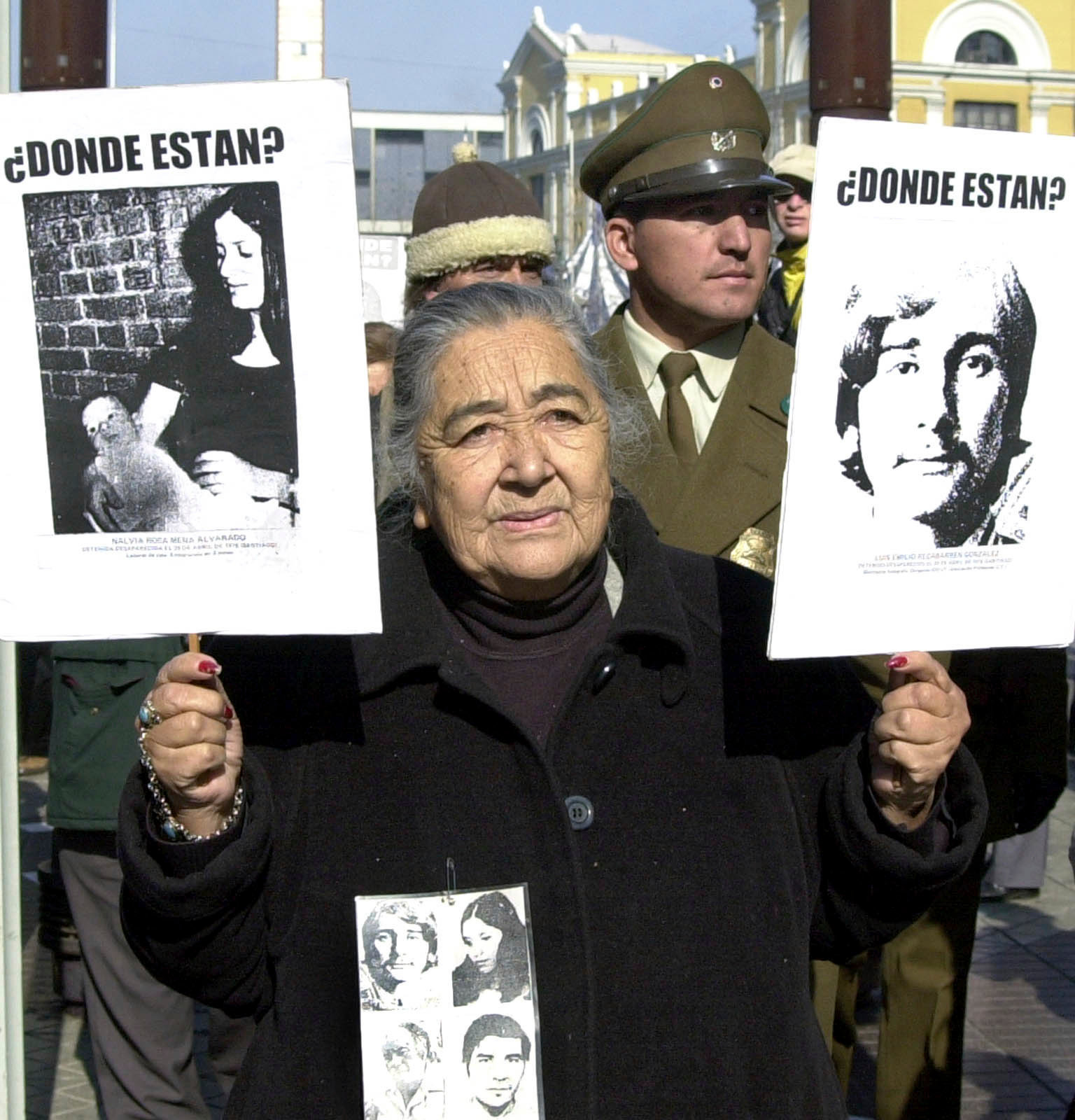 Ana González at a 2002 protest with pictures of her missing family members Photo: Santiago Llanquin/Associated Press via CBC