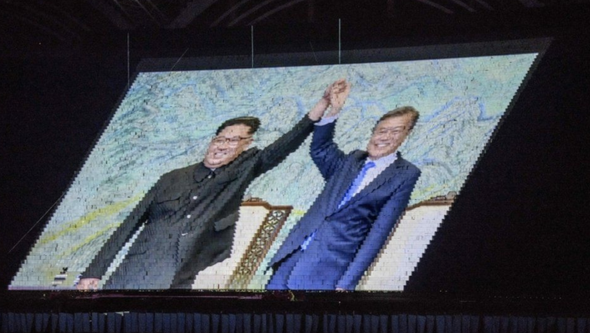An image of North Korean leader Kim Jong-un (left) and his South Korean counterpart Moon Jae-in at a prior summit was also rendered by a “human pixel” screen at the Games. Photo: AFP .