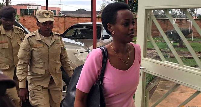 On Nov. 7, 2017, Police officers escort Rwigara into a courtroom in Kigali, Rwanda. Credit: Jean Bizimana/ Reuters via Channel News Asia