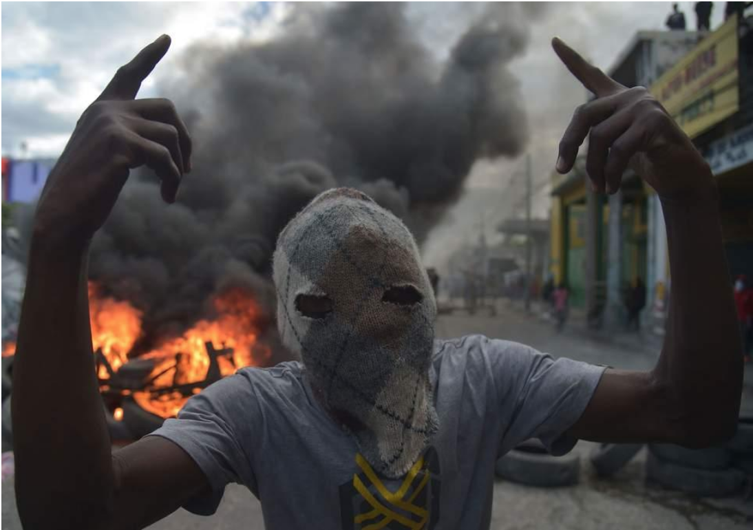A masked demonstrator in Port-au-Prince Source: AFP/ Independent