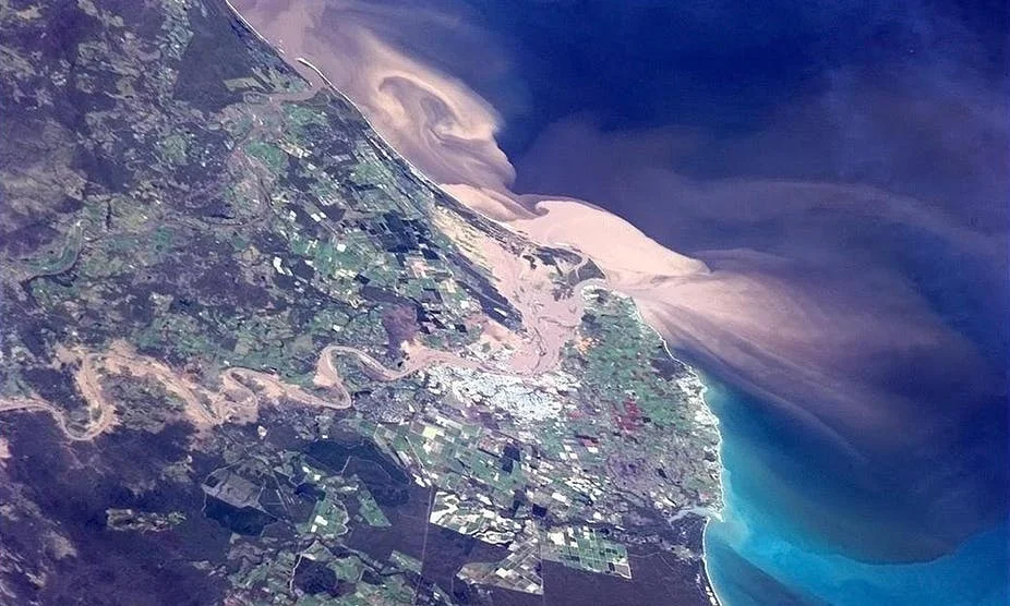 A flood plume containing sediments, nutrients and pesticides flowing onto the Great Barrier Reef from Bundaberg. Photo: James Cook/ AAP Image