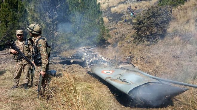 Pakistani soldiers stand by what they claim is wreckage from an Indian jet; Photo: BBC