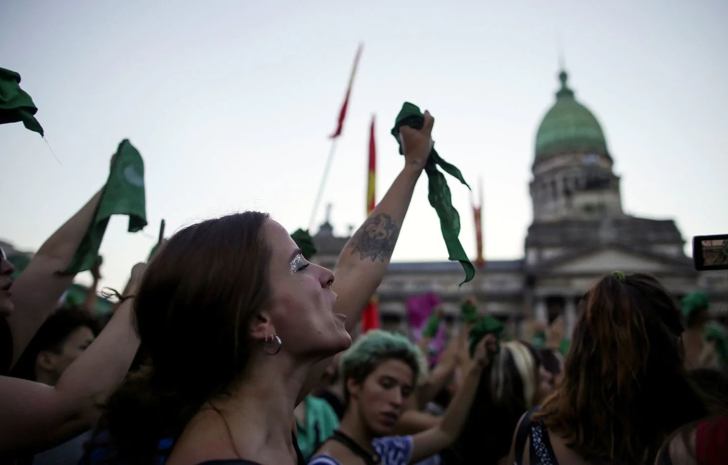 A demonstrator waves a green handkerchief at an abortion rights protest outside the Argentine National Congress in Buenos Aires. Photo: Agustin Marcarian/Reuters via The Washington Post .