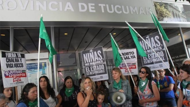 Pro-choice activists protest outside the Tucumán Provincial Government building, holding signs that read “Girls, not mothers. The state is responsible.” Photo: EPA via BBC News .