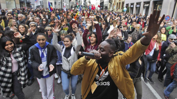 Saturday March 2 DJ Simon Samaki Osagie leads protestors in song at an anti-racism rally in Milan. Photo: AP