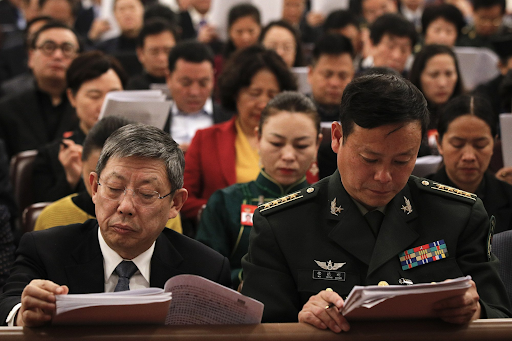 Delegates read work reports delivered by Chinese Premier Li Keqiang during the opening session of the National People’s Congress in the Great Hall of the People on Mar. 5, 2019. Photo: Andy Wong/AP