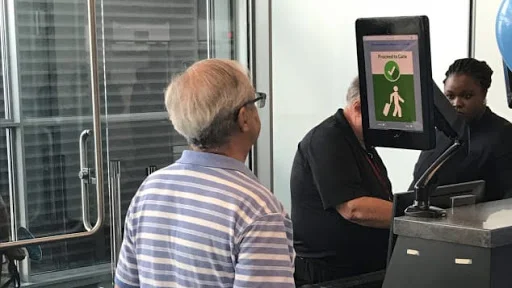 A photo of a man taking a facial recognition photo at the airport. Photo Credit: Gregory Wallace /CNN