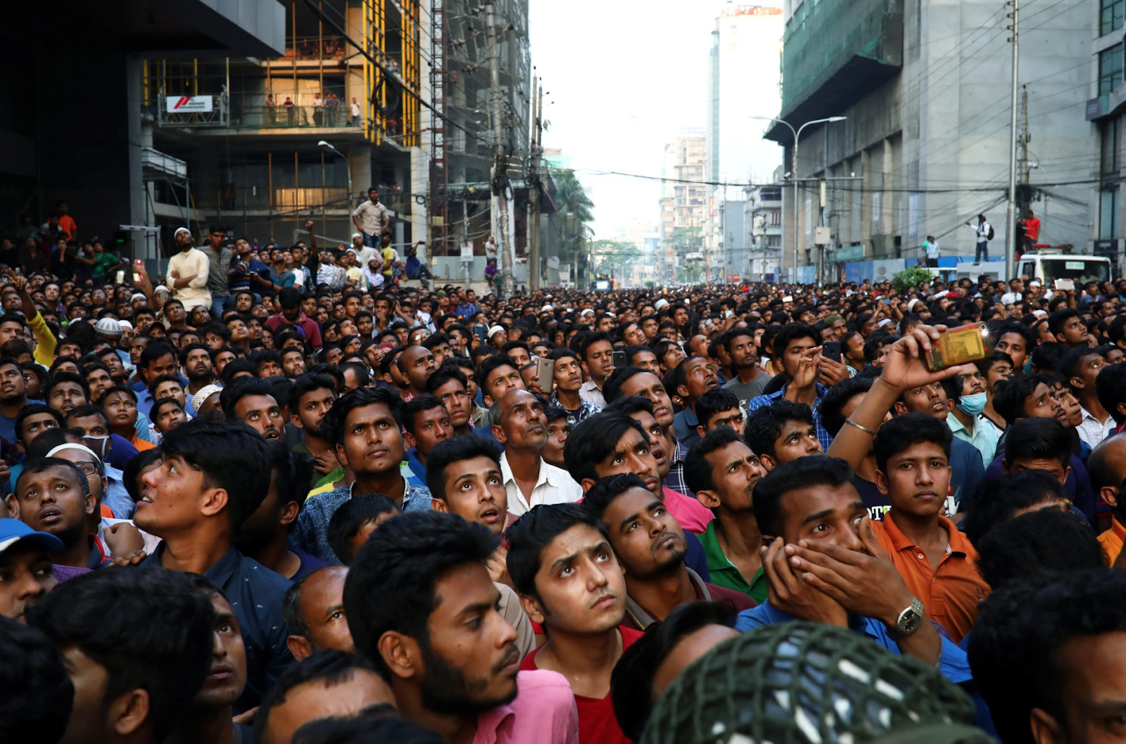 Hundreds of horrified onlookers were witness to the civilians jumping from the blazing building. Photo: Mohammad Ponir Hossain/Reuters