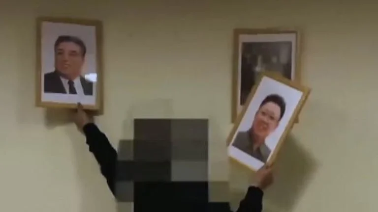 Anti-Kim organization Cheollima Civil Defense posted a video on its website in which one of the members shatter portraits of Kim Jong-un and former leader Kim Il-sung. Photo: Sky News
