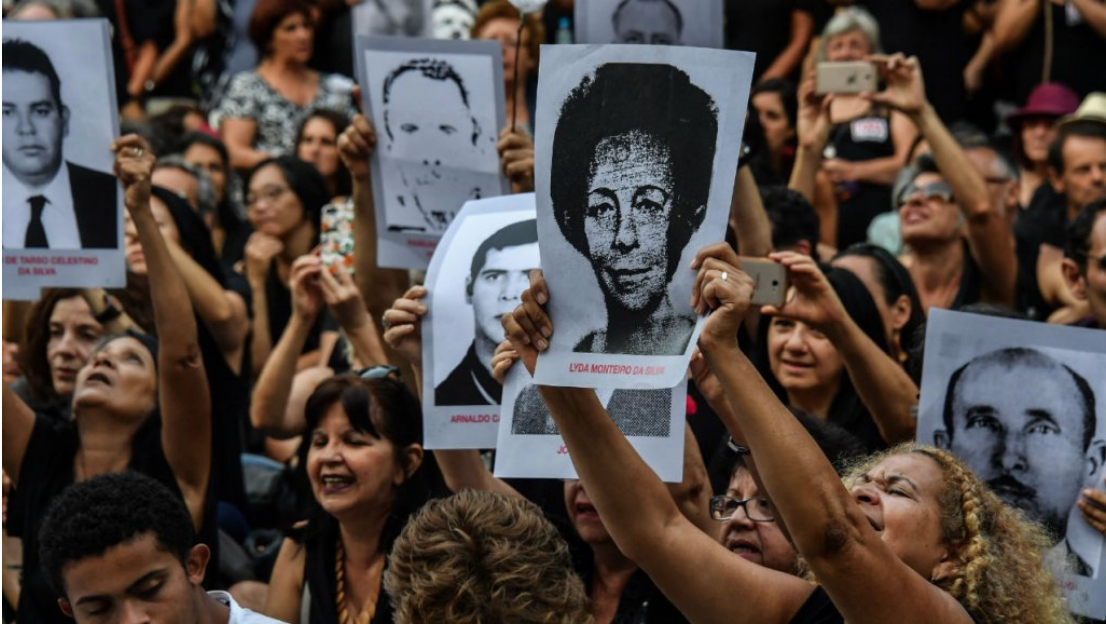 Protestors holding up photographs of individuals who went missing during the dictatorship as part of the demonstrations in Rio de Janeiro. Photo: Nelson Almeida/ AFP/ France 24