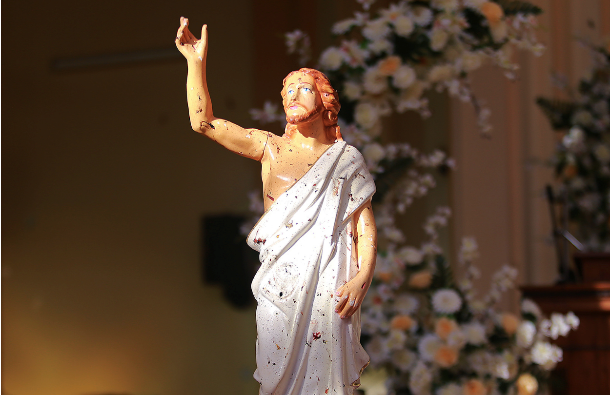 Blood stains are visible on a statue of Jesus Christ after a bomb detonated inside a church in Negombo city in Sri Lanka on Sunday, April 21. Photo: Reuters