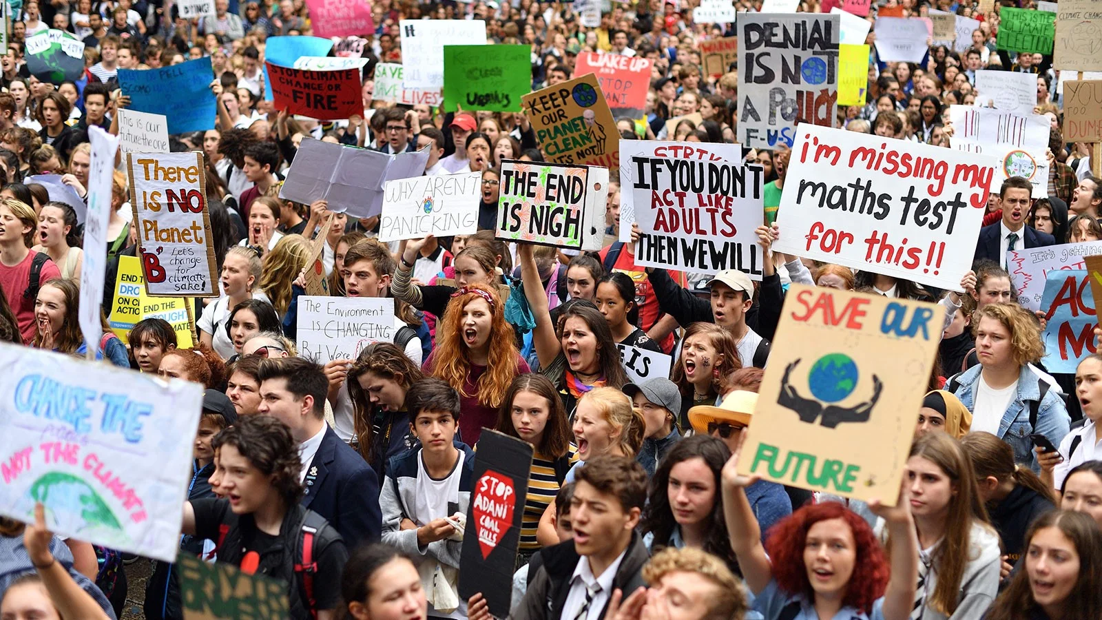 Youth protesters yell and hold signs at New York City’s Climate Strike. Photo: Saeed Khan/ Grist