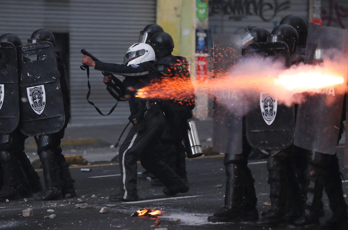 Members of the riot police aim their weapons as they clash with demonstrators during protests. Photo: Ivan Alvarado/REUTERS