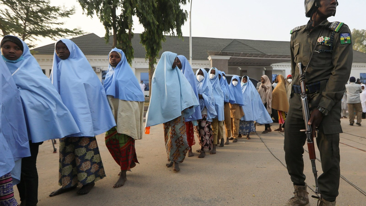 A police officer protects the women. Photo:  Council on Foreign Relations