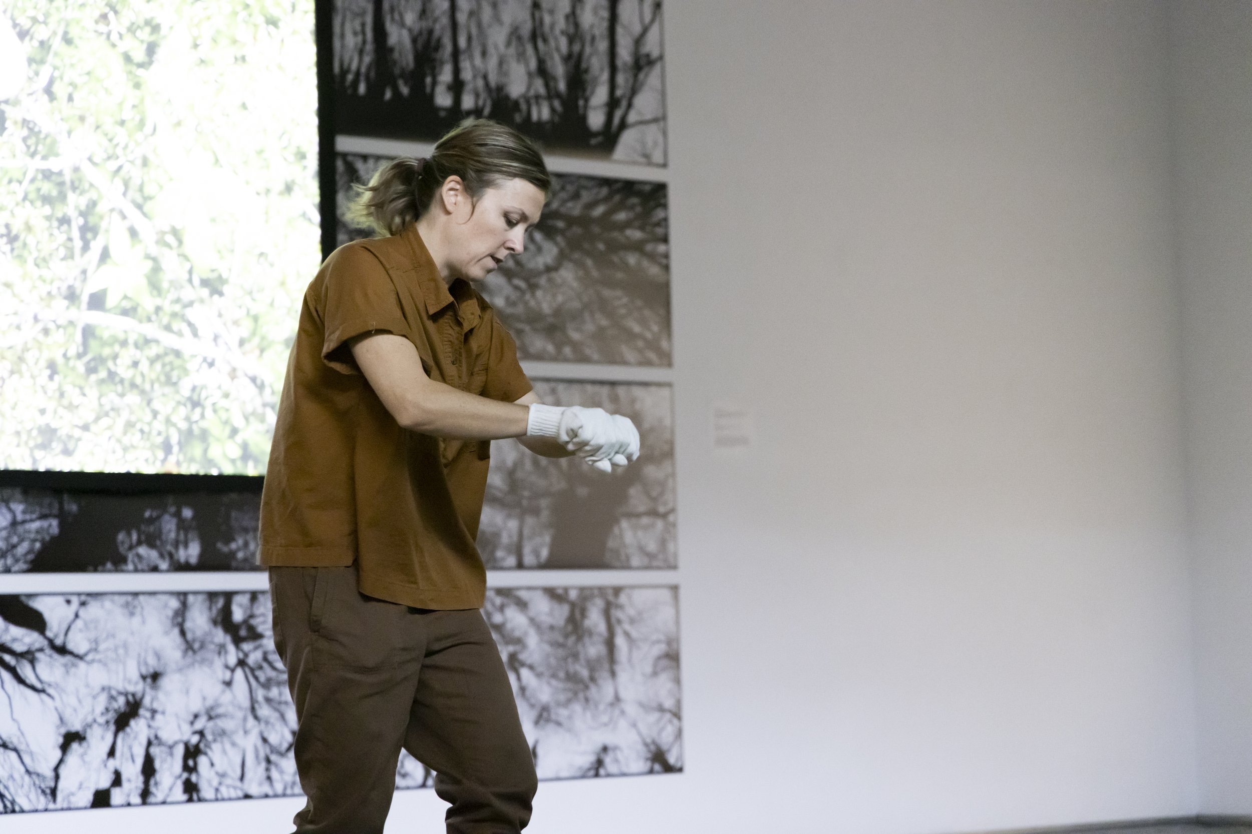  Katie Kehoe presenting a performance artwork, 200 Trees: A Performance Action, as a companion piece to a video installation she is presenting in the gallery. Photo by: Cristian Torres/Strategic Communications/George Mason University 