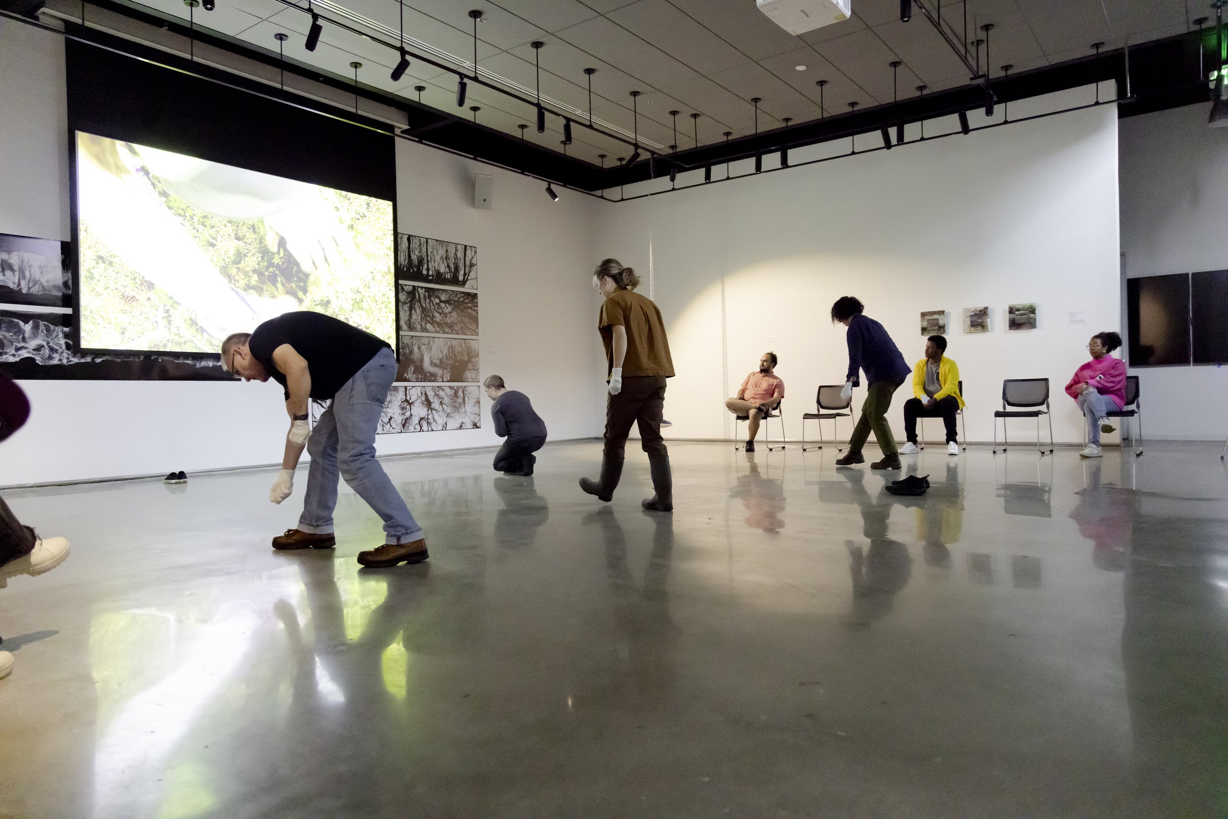  Katie Kehoe presenting a performance artwork, 200 Trees: A Performance Action, as a companion piece to a video installation she is presenting in the gallery. Photo by: Cristian Torres/Strategic Communications/George Mason University 