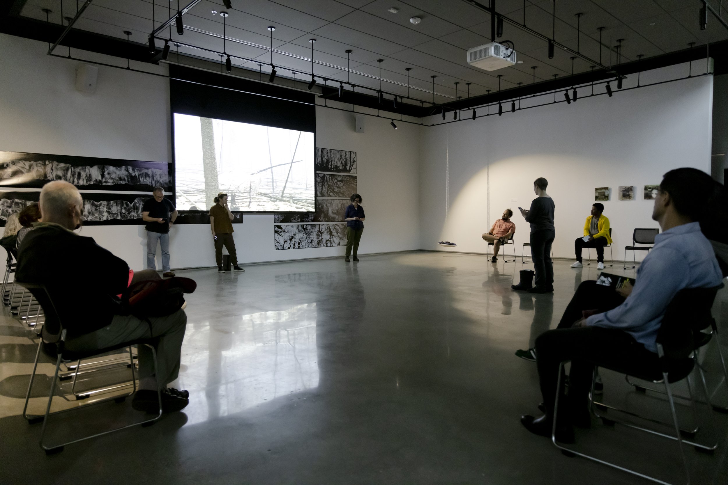  Katie Kehoe presenting a performance artwork, 200 Trees: A Performance Action, as a companion piece to a video installation she is presenting in the gallery. Photo by: Cristian Torres/Strategic Communications/George Mason University 