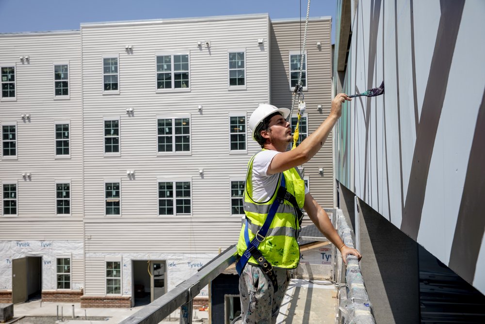  Artist Nicholas Zimboro paints mural for GMU's new off-campus housing The Flats. Photo by:  Sierra Guard/Creative Services/George Mason University 