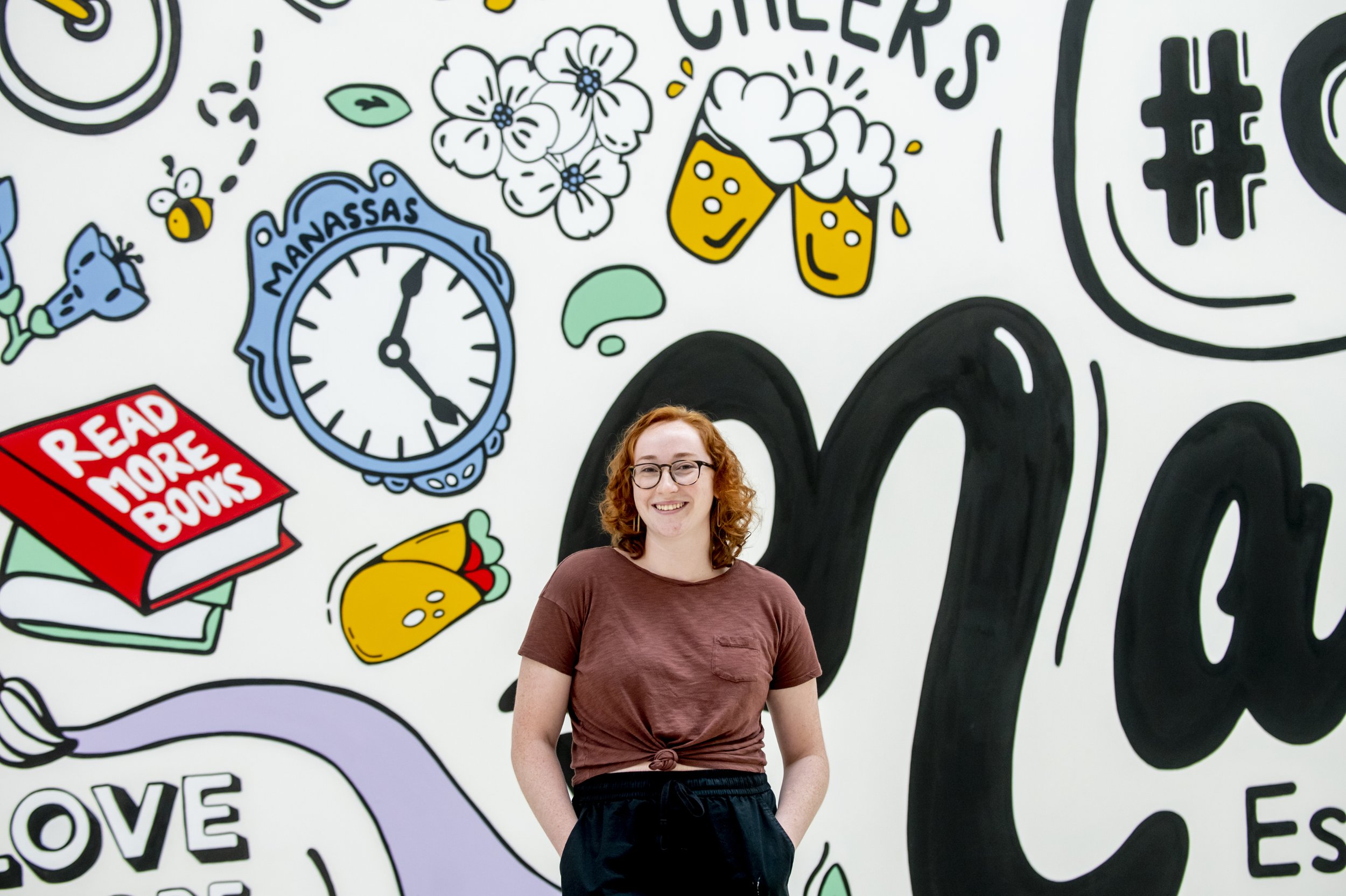  Artist Emma Dardis paints mural for Manassas Mall. Organized by Murals at Mason. Photo by:  Sierra Guard/Creative Services/George Mason University 