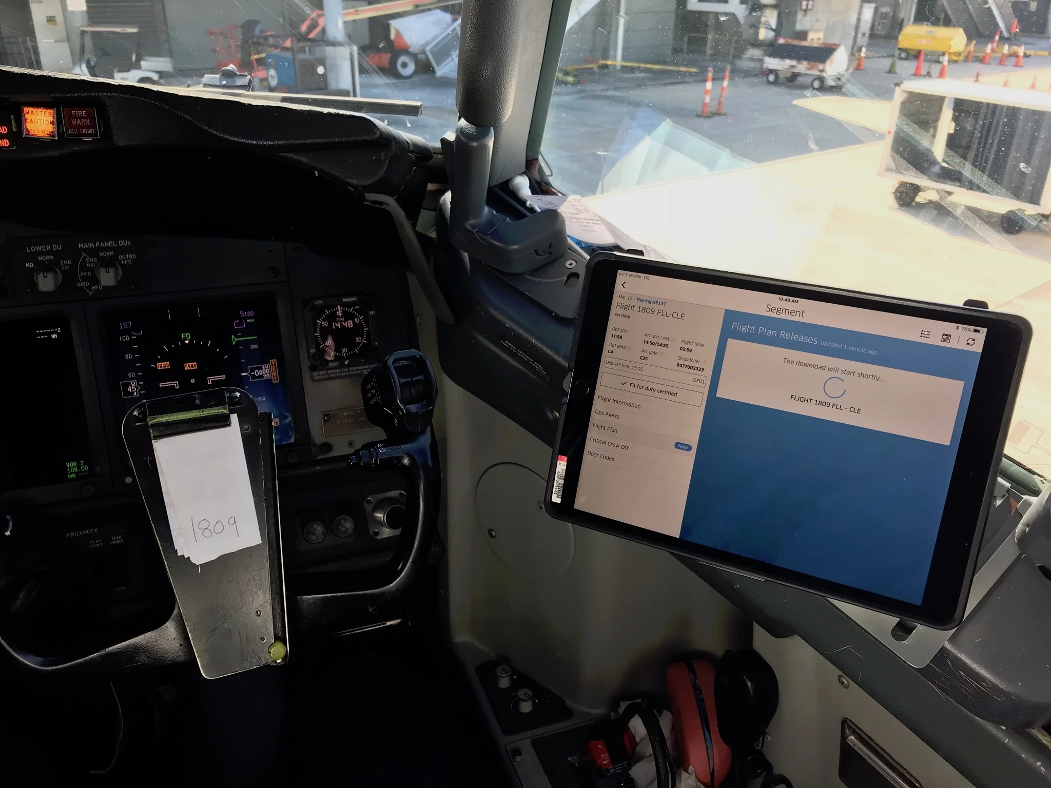 Pilot’s iPad with mounts are suction-cupped to the windshield in the flight deck. The lid can be unclipped, then the case and iPad can be attached to the mount: