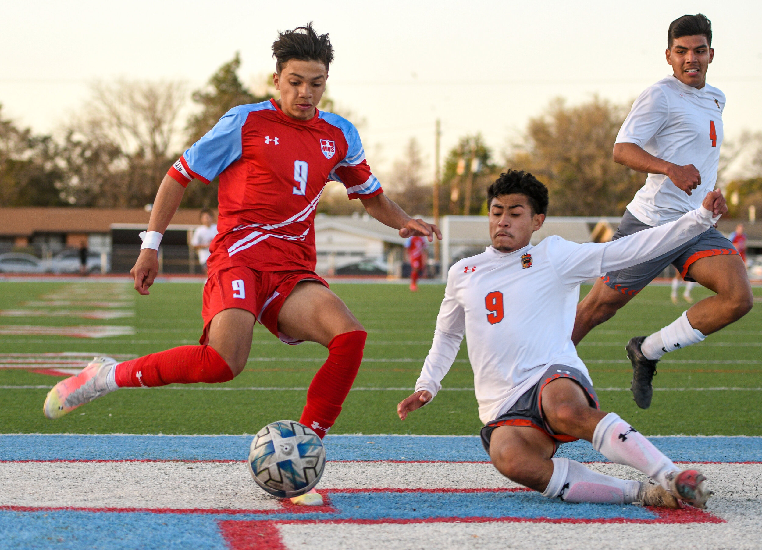 Monterey’s Edgar Gonzalez gets slide tackled by a Canyon defender during the soccer match against Canyon on Friday, March 26, 2021, at Monterey High School in Lubbock, Texas.  