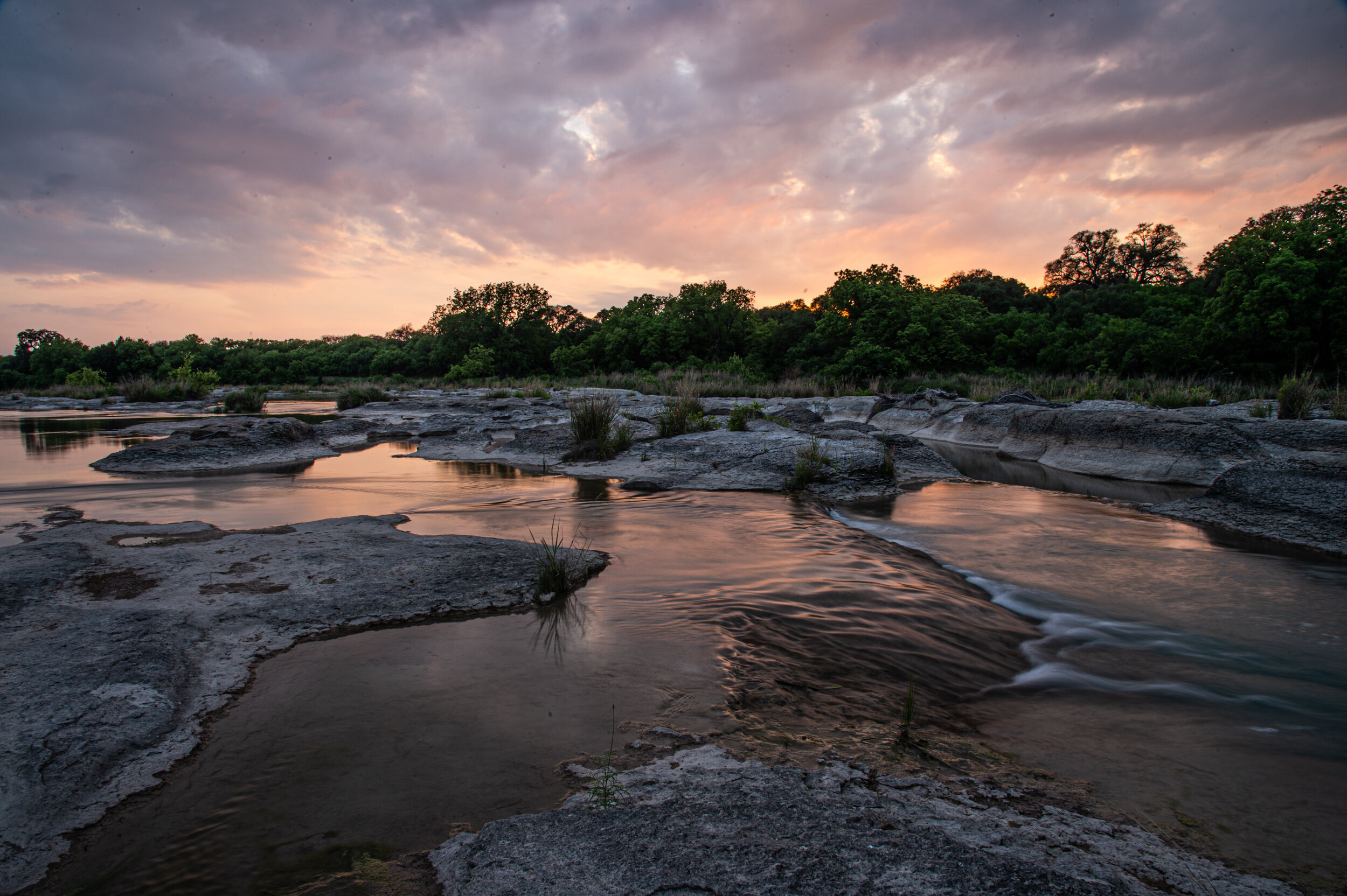  The Llano River runs through the Llano River Ranch at sunset on May 16, 2021, in Junction, Texas. 