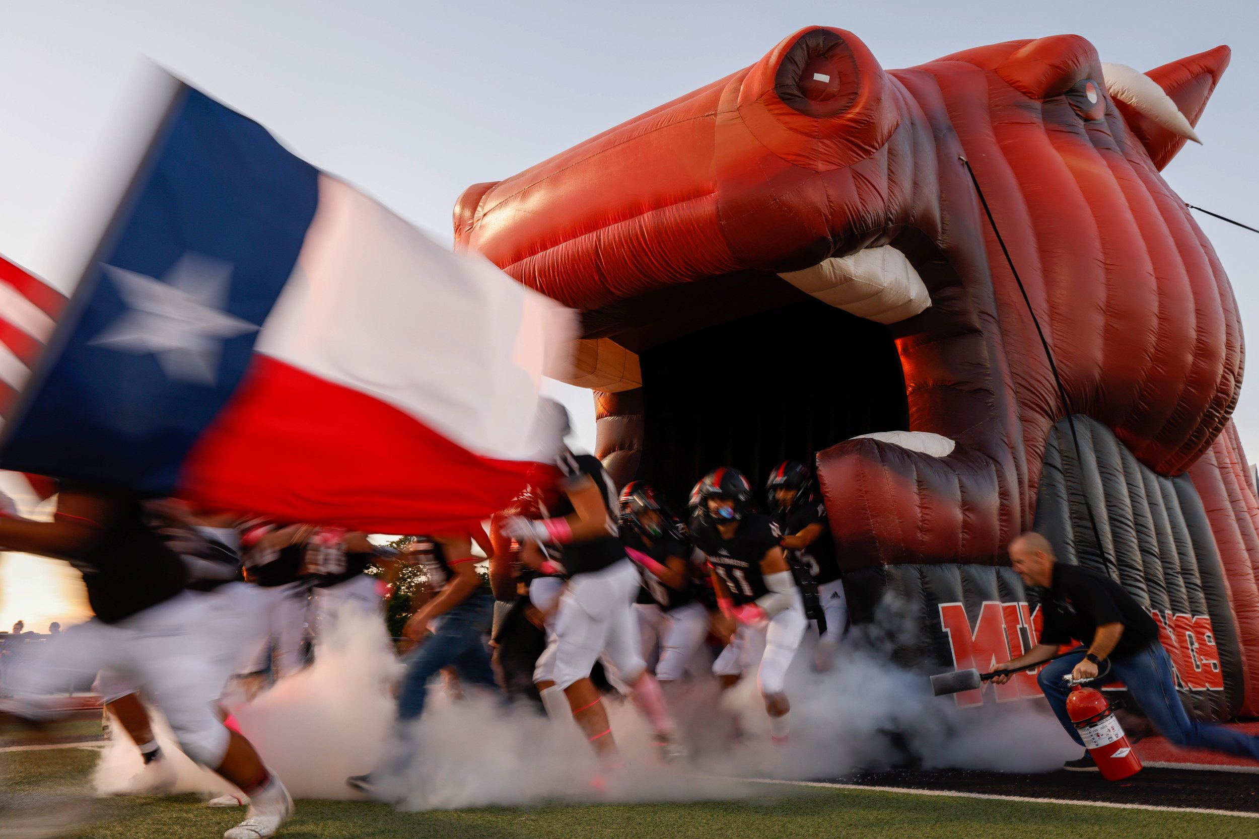  The Shallowater football team runs out of the tunnel before the team’s high school football game against Denver City Friday, Oct. 22, 2021 at Todd Field in Shallowater, Texas. 