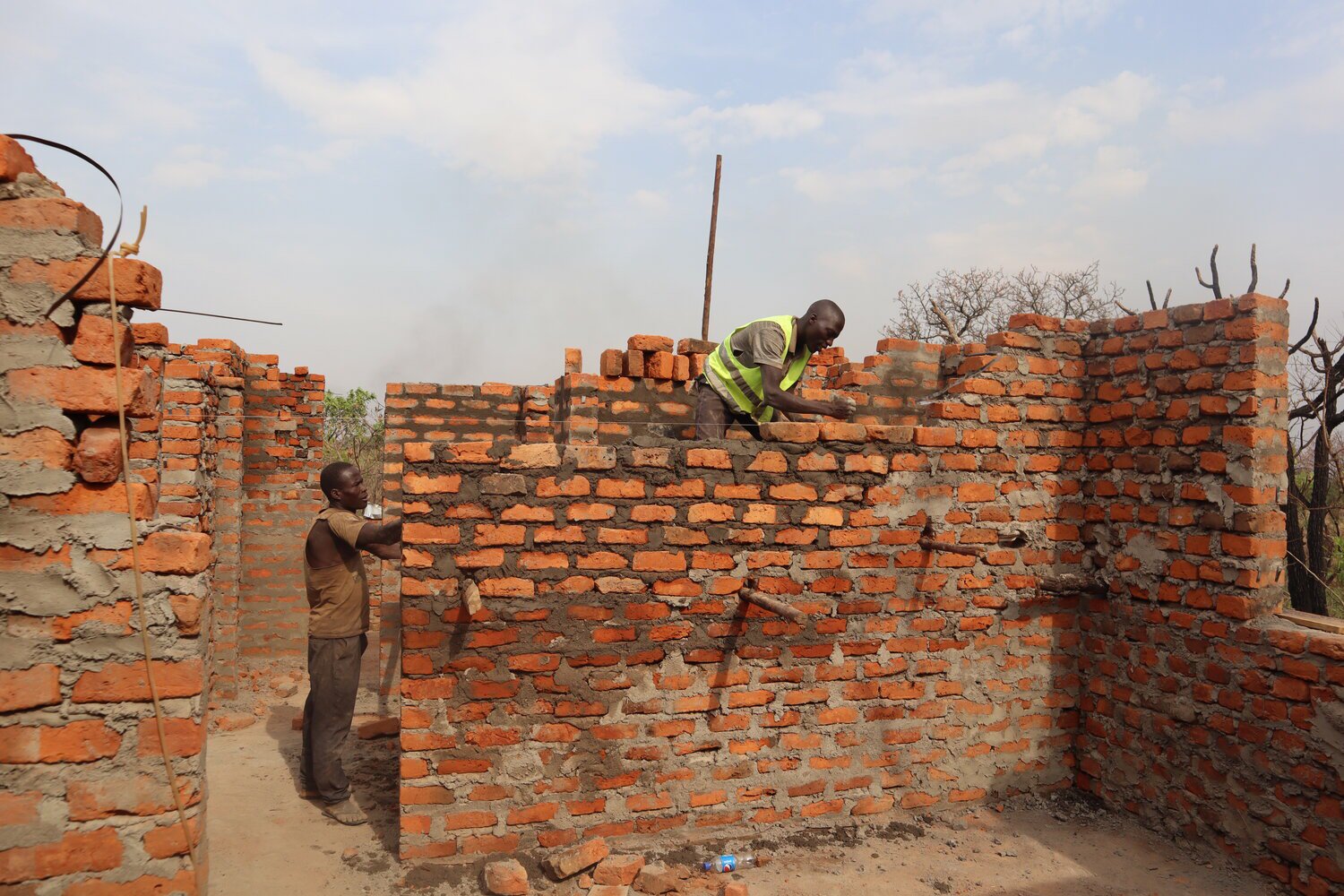 Construction workers building out the main wall of one of the rooms