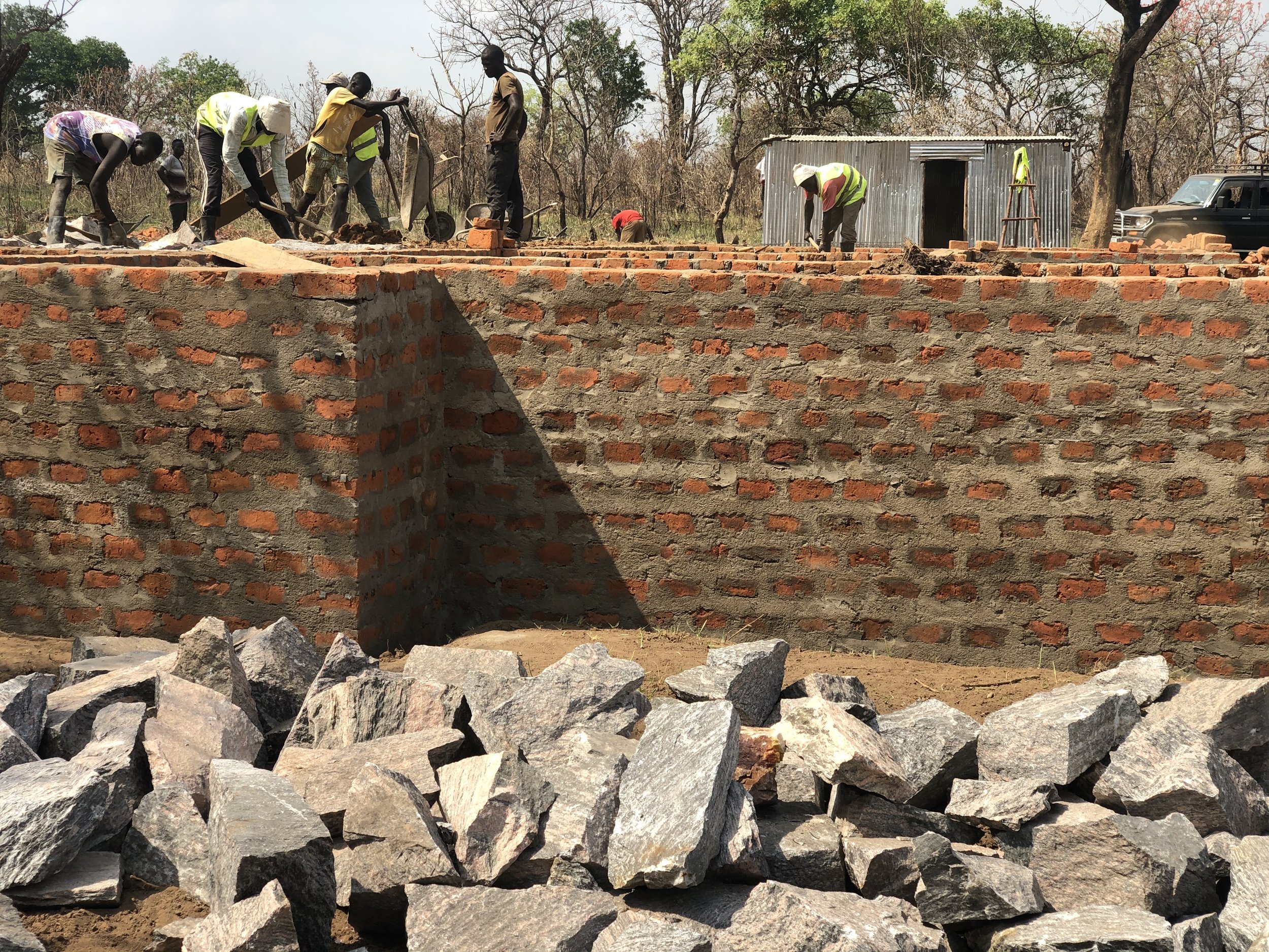 Builders preparing the cast the foundation with hardcore rocks