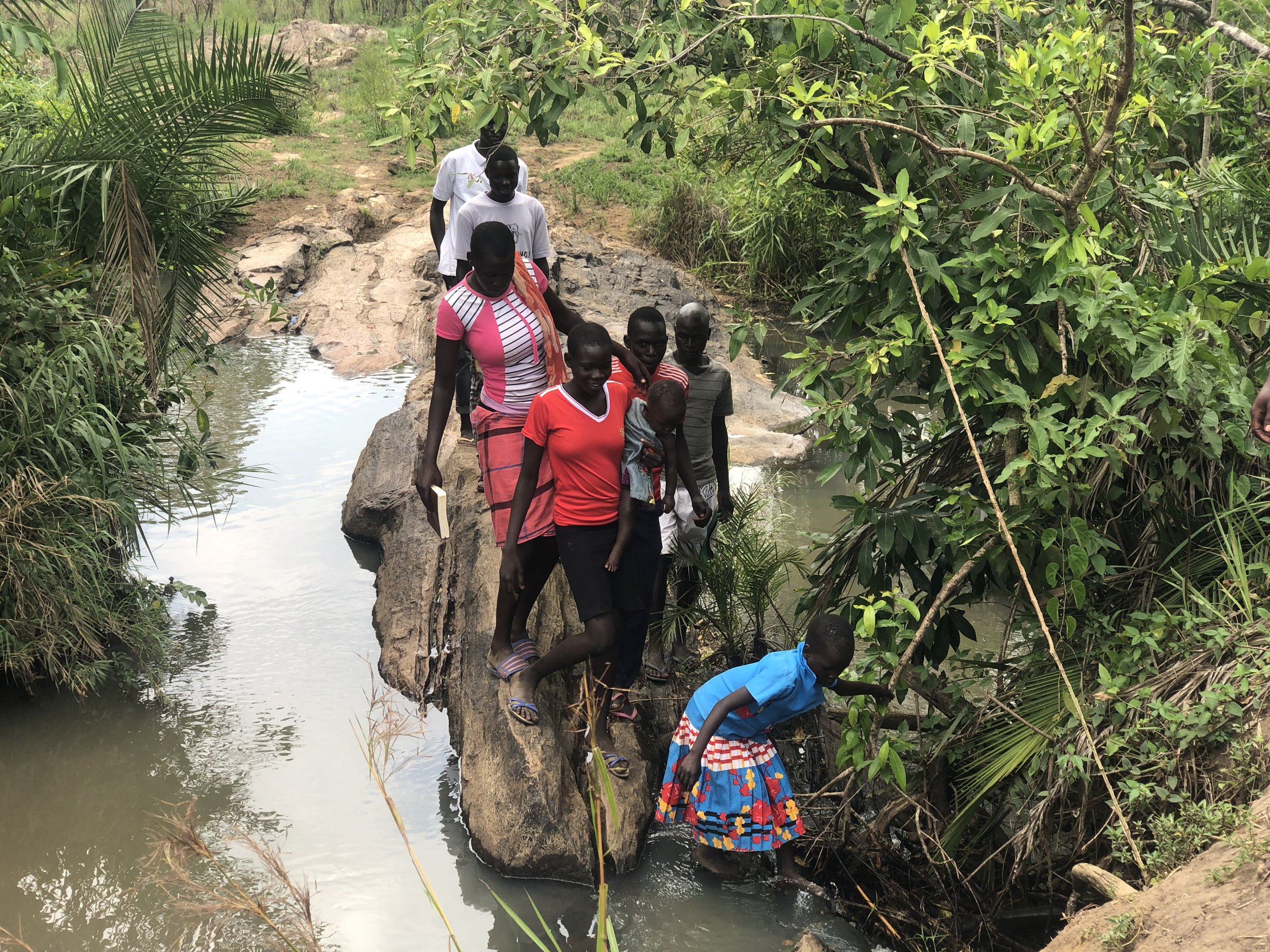 TWCC members- children and youth- crossing one of the rivers used to reach out church weekly