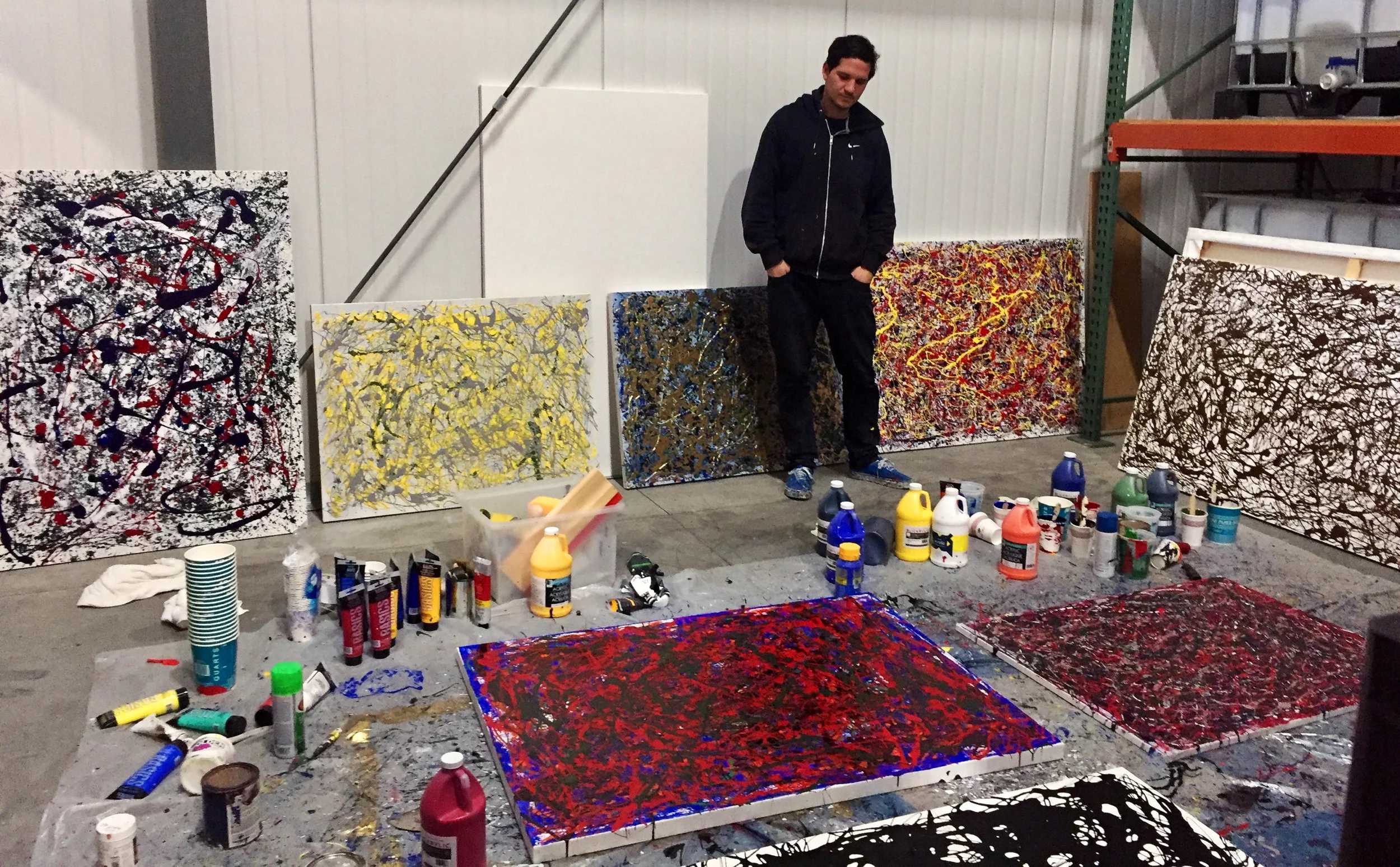 Chris with paintings.jpg