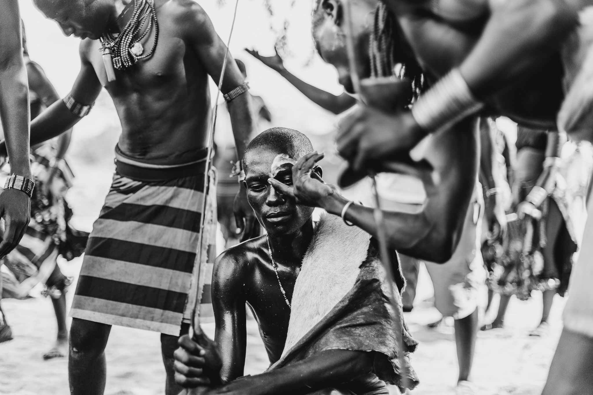 Like the women, the men have their own form of beautification as they mix paints from natural sources and help decorate each others faces.
