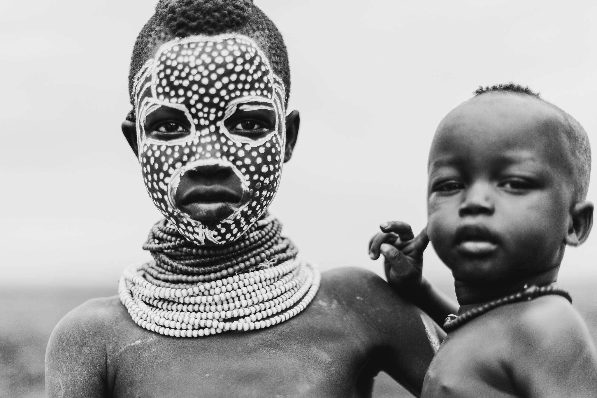 In Karo culture, the girls always wear a complex layer of handmade necklaces. The boys often wear an individual necklace, but never any adornments on their arms.
