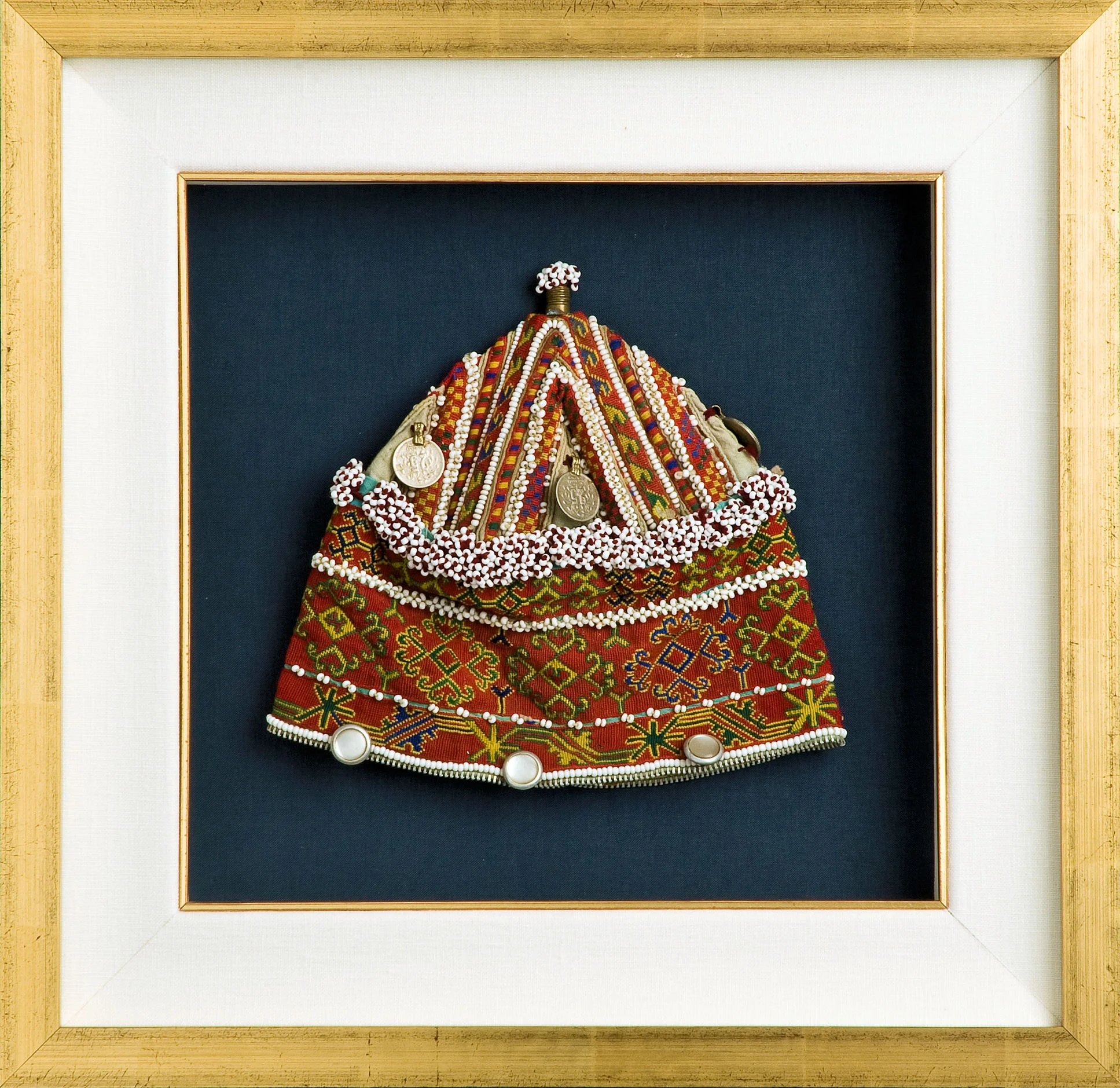 Fabric items like this Tibetan cap are highly vulnerable to fading caused by UV light. The deep blue fabric mat can likewise fade over time. We selected Museum Glass for maximum protection and minimum glare.